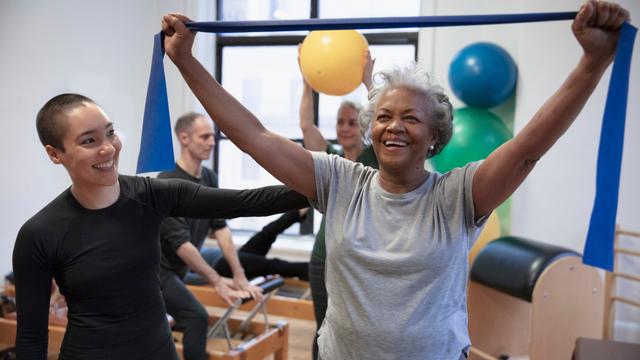 a woman with grey hair does exercise